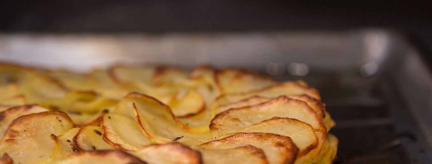 Duck Fat Potato Galette with Caraway and Sweet Onions cooking